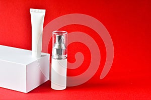 Design of natural cosmetic cream, serum, skincare blank bottle packaging, bio organic product on a red background. beauty and spa