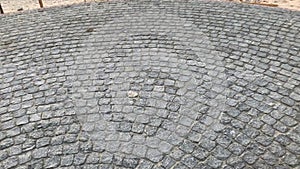 Design of paving stones in a circle on a terrace, road or sidewalk.