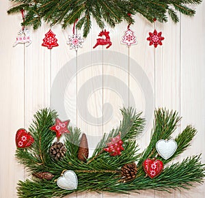 Design for postcards, place for text. Branches of a Christmas tree, New Year`s decor on a light wooden background. Macro.