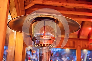 Design stainless steel metal gas burning indoor patio heater with blurred enteriour background