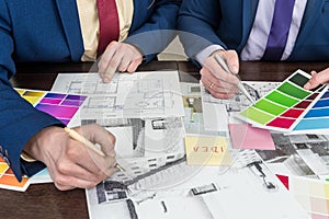 Design team working at office under house project. Apartament scetch with color palette photo