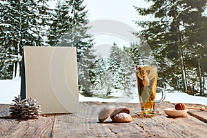 Design for wallpaper. Autumn or winter still life with hot tea with fruit, berries and spices in glass cup. Healthy