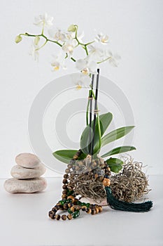 Design with white orchids and string rosary