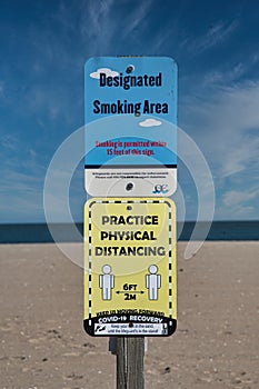 Designated Smoking Area and Social Distancing Signs on Beach in Ocean City Maryland