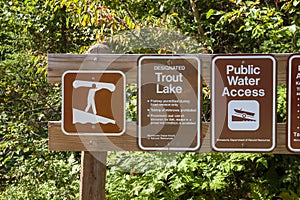 Designated trout lake sign at a northern Minnesota campground on a sunny fall afternoon