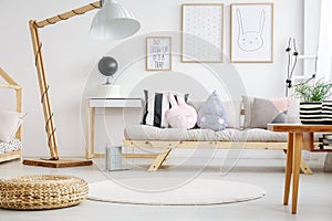 Designed lamp near beige sofa
