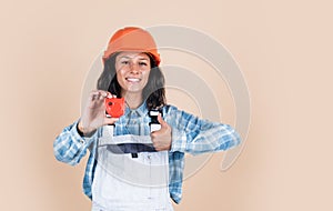 Designed to preform. technician working using tape measure tool. safety uniform. equipment for repairing. mechanic girl