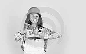 Designed to preform. technician working using tape measure tool. safety uniform. equipment for repairing. mechanic girl