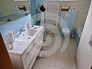 designer bathroom with glossy turquoise tiles. green and white