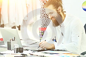 Designer with a beard is working on new collection