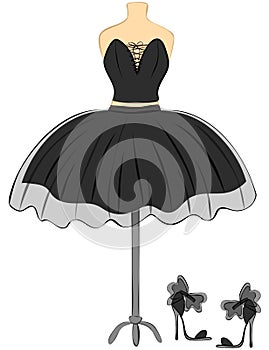 Designer black dress on a mannequin with shoes. Vintage outfit for the girl.