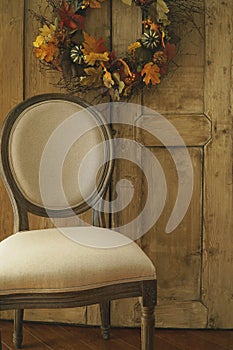 Designer chair with wreath on door