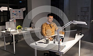 Designer with computer and pen tablet at office