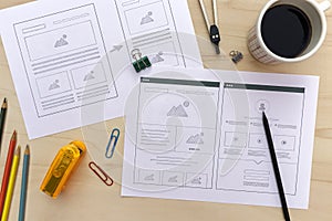 Designer desk with website wireframe sketches