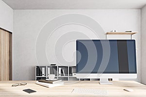 Designer desktop with empty black computer screen