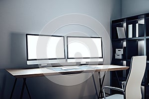 Designer desktop with two empty computer screen