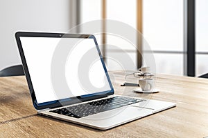 Designer desktop with white laptop