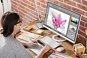 Designer Drawing Flower On Computer Using Graphic Tablet