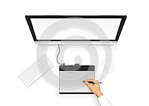 Designer drawing on graphic tablet near pc monitor blank screen.