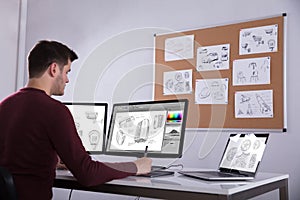 Designer Drawing Suitcase On Computer Using Graphic Tablet