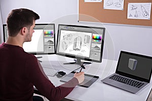 Designer Drawing Suitcase On Computer Using Graphic Tablet