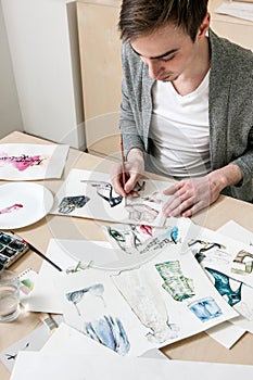 Designer of fashion indusrty works on sketches