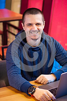 Designer or freelance developer smiling and looking in camera