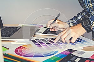 Designer graphic creative working on Mouse pen laptop in office