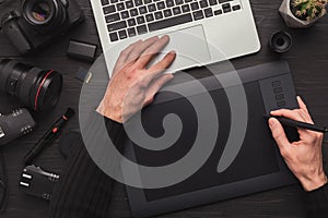 Designer hand with graphic tablet and keyboard