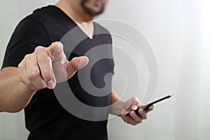 Designer hand pressing an imaginary button,holding smart phone,digital screen graphic virtual icons,graph,diagram