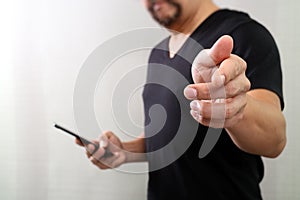 Designer hand pressing an imaginary button,holding smart phone,digital screen graphic virtual icons,graph,diagram,filter effect
