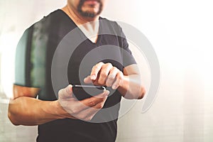 Designer hand using smart phone for mobile payments online shopping,omni channel,on white background,filter effefct