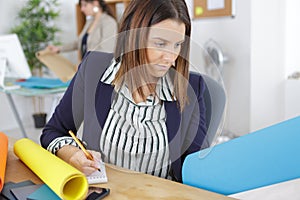 Designer holding blue colored paper