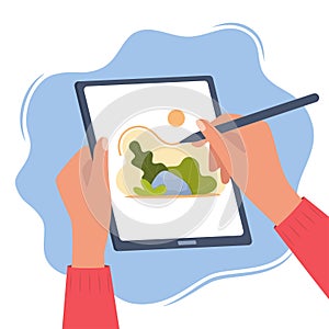 Designer illustrator draws a cute illustration on graphic tablet with pen. Hands holding tablet and stylus pen. Art creating,