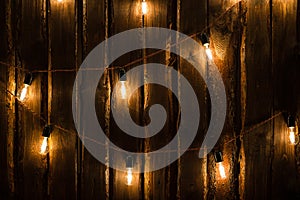 Designer light bulbs on dark wooden background