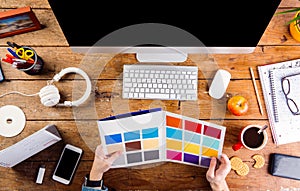 Designer at office desk working with color swatches