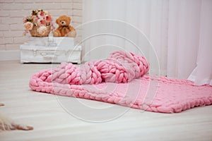 designer pink Merino blankets spread out on the floor.