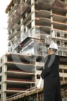 Designer Pointing At Building Under Construction