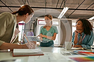 Designer showing designs of trendy dress to women