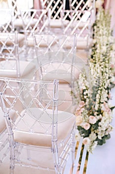 Designer transparent chairs with rhombus pattern vvide in the area of wedding decoration Flower arrangements