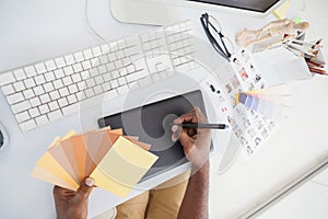 Designer using digitizer and colour wheel