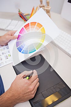 Designer using graphics tablet and colour wheel