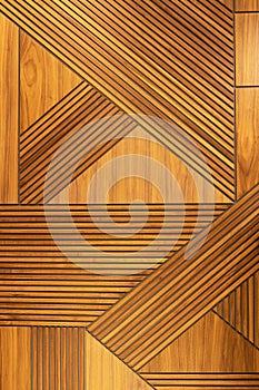 Designer walnut veneer panel, geometric crisscross pattern wood wall. Architectural background, texture. The concept is a modern photo
