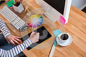Designer working with colour wheel and digitizer photo
