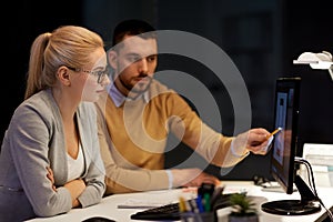 Designers with mockup on computer screen at office