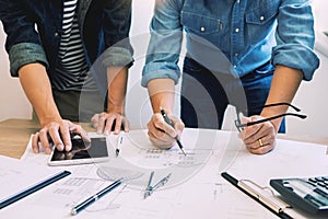 Designers in the office are working Discussion Blueprint Architect on a new project Design Draw Teamwork on wooden desk