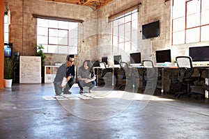 Designers Planning Layout On Floor Of Modern Office