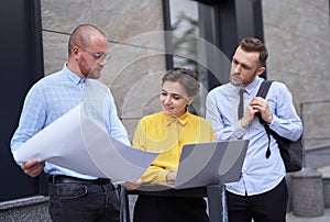 Designers team discussing project presentation outdoors