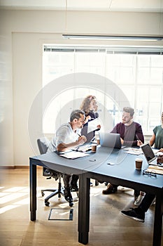 Designers working on a project together in an office