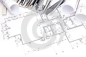 Designers workplace with drawing tools and floor plan